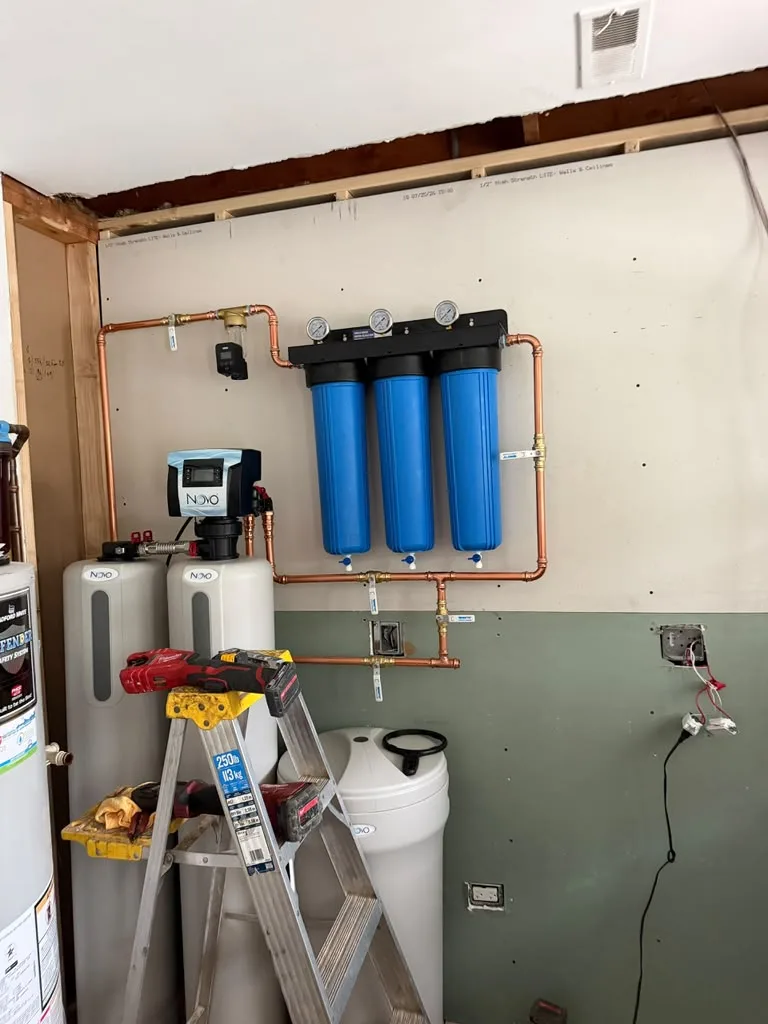 Whole-home water filtration and softener system with three filter housings and copper piping